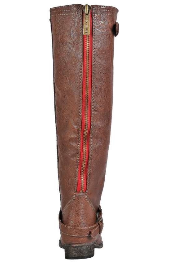 Riding boots with red zipper top in back